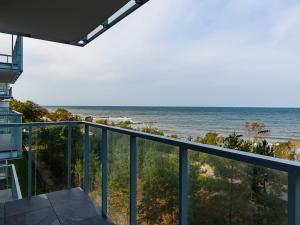 a view of the ocean from the balcony of a house at VacationClub – Jantaris Apartament B34 in Mielno