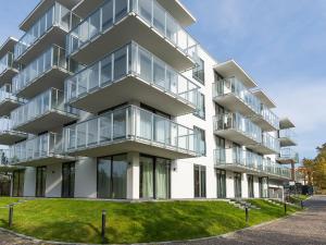 an apartment building with large glass balconies at VacationClub – Jantaris Apartament B35 in Mielno