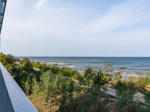 a view of the beach from the balcony of a house at VacationClub – Jantaris Apartament B35 in Mielno