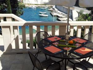 a table on a balcony with a view of the water at Villa Jade Apartments FRONT ROW SEA VIEW - WALK TO KORCULA OLD TOWN in Korčula