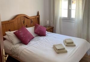 a bedroom with a bed with two towels on it at Wonderful Penthouse in Nerja