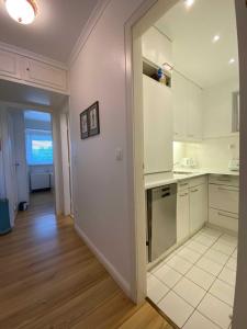 a kitchen with white cabinets and a door leading to a hallway at PiPPA in List