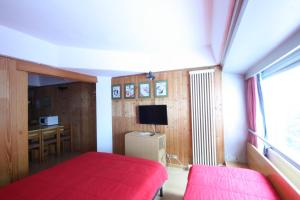 מיטה או מיטות בחדר ב-Sole Alto Appartamenti Montana