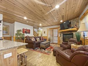 a living room with leather furniture and a fireplace at Timberwolf Lodge 6 cabin in Park City