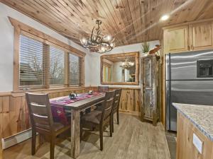 a dining room with a table and chairs and a refrigerator at Timberwolf Lodge 6 cabin in Park City