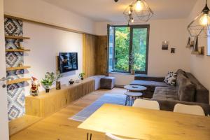 a living room with a couch and a table at Apartments FRUTIS in Bjelašnica