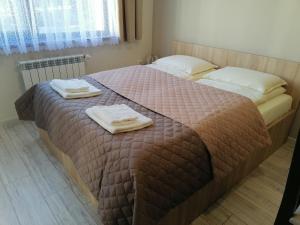 A bed or beds in a room at Borovets Gardens Apartment A27