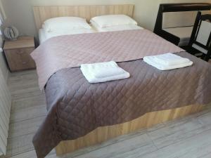 A bed or beds in a room at Borovets Gardens Apartment A27