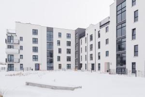 a row of white buildings in the snow at Apartament Hania in Gdańsk