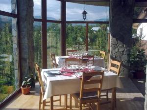 a dining room table with a white table cloth and chairs at Casa Moroeni in Moroeni
