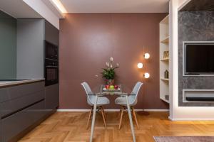 a kitchen and dining room with a table and chairs at Onira Suite Dreams in Hersonissos