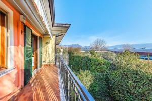 a balcony of a house with a view of the water at La Piopa 2 20 Apartment by Wonderful Italy in Polpenazze del Garda
