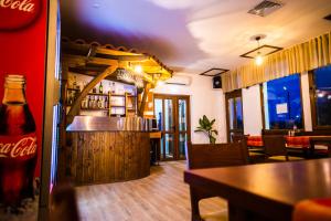 a bar in a restaurant with a coke bottle at Семеен Хотел Петров Хан in Poroishte +4 photos