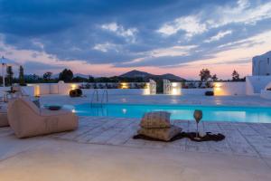 a villa with a swimming pool at night at Naxian Lounge Villas in Naxos Chora
