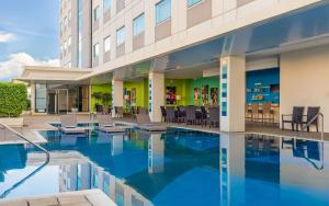 a swimming pool in front of a building at Park Inn by Radisson Davao in Davao City