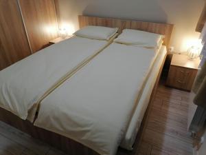 A bed or beds in a room at Borovets Gardens Apartment A27