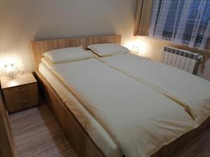 A bed or beds in a room at Borovets Gardens Apartment A27