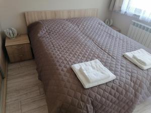 A bed or beds in a room at Borovets Gardens Apartment A27