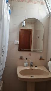 a bathroom with a sink and a mirror at Apartamentos El Valle in Frontera +19 photos