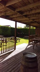 a wooden deck with a picnic table and a barrel at The Anchorage in Troon +22 photos