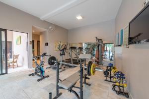 a gym with several exercise equipment in a room at Class Hotel Alfenas in Alfenas