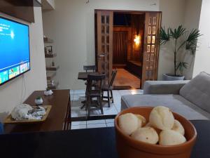 a living room with a bowl of bread on a table at Casa Recanto do sol in Natal