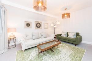 a living room with two couches and a coffee table at The Tower by Harrogate Serviced Apartments in Harrogate