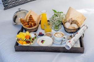 a tray of breakfast foods and coffee on a table at Soho Boutique Castillo de Santa Catalina - Adults Recommended in Málaga