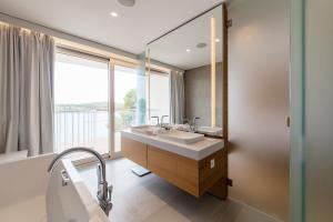 a bathroom with two sinks and a large window at D-Resort Šibenik in Šibenik