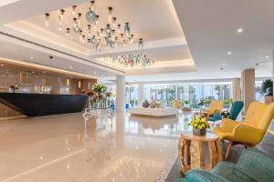 a large lobby with chairs and a chandelier at Sealine Beach, a Murwab Resort in Mesaieed