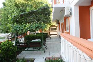 a balcony with chairs and plants on a building at Apartments Brnjada in Sutomore