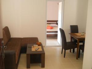 a living room with a couch and a table at Apartments Brnjada in Sutomore
