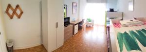a room with a bedroom with a bed and a television at Pensión Pamplonabeds in Pamplona