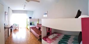a room with a bed and a living room at Pensión Pamplonabeds in Pamplona