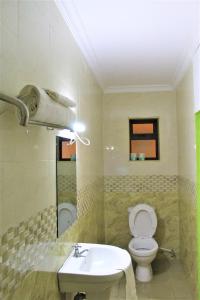 a bathroom with a toilet and a sink at Hotel Kepler in Nairobi