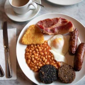a plate of breakfast food with beans and a cup of coffee at The Anchorage Hotel in Troon