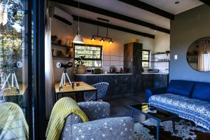 a living room with a couch and a table at Hadada Self Catering Studio in Haga-Haga