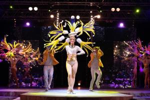 a woman in a costume on a stage at Camping Arinella Bianca in Ghisonaccia