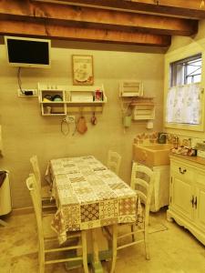 a kitchen with a table and a sink and a tv at B & B San Domenico in Chioggia