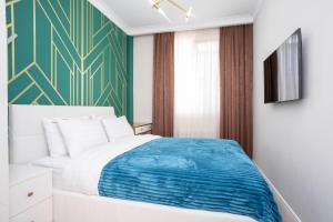 a bedroom with a bed and a green wall at Art Lite One RED APARTMENTS in Adler