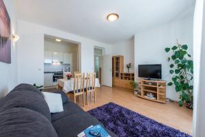 a living room with a couch and a dining room at Apartment Lena in Dubrovnik