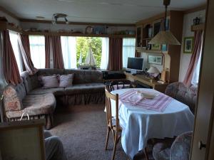 a living room with a couch and a table at Camping Boetn Toen Pieterburen in Pieterburen