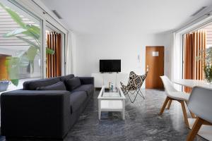 a living room with a couch and a table at numa I Jondo Apartments in Seville