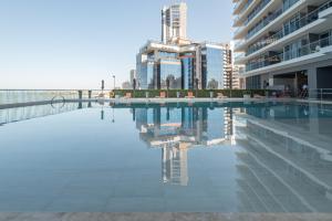 a swimming pool in a city with tall buildings at Beachfront Paradise with Outstanding Sunset Views in Cartagena de Indias