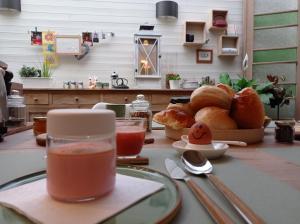 a table with a plate of bread and a cup of tea at B&B Emma in Bruges