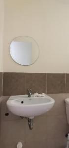 a white sink in a bathroom with a mirror at HUGE STUDIO @ Arezzo place Davao condominium in Davao City
