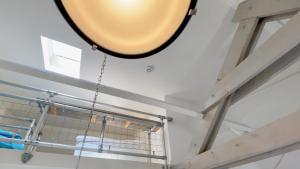 a large mirror hanging from the ceiling in a room at Alta Mar Studios in Scheveningen +27 photos