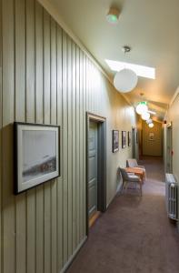 a hallway with a tv on a wall at Fosshotel Eastfjords in Fáskrúðsfjörður