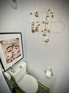 a bathroom with a white toilet and a picture at Unique Apartment - Costa Plana in Cap d'Ail