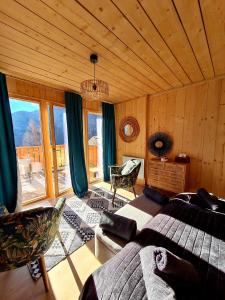 a bedroom with a bed and a large window at Le Chalet Du Blanc Spa yoga in Aillon-le-Jeune
